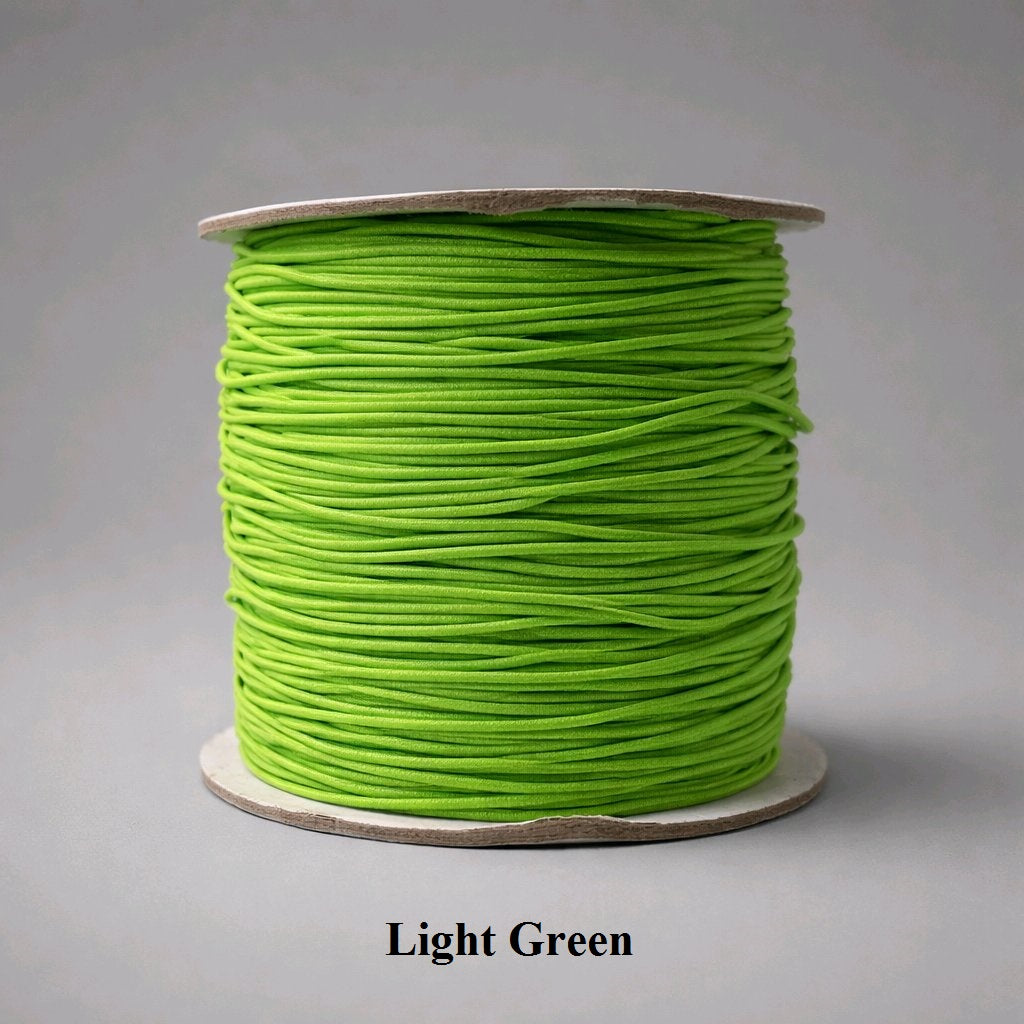 1mm light green elastic cord with a smooth nylon texture. This soft minty shade is perfect for subtle, organic-style jewelry and botanical bead palettes