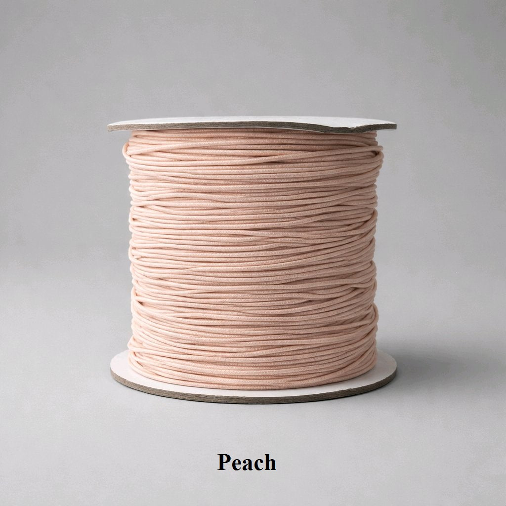 Soft, pastel peach 1mm elastic cord showing a smooth nylon texture and delicate orange-pink hue