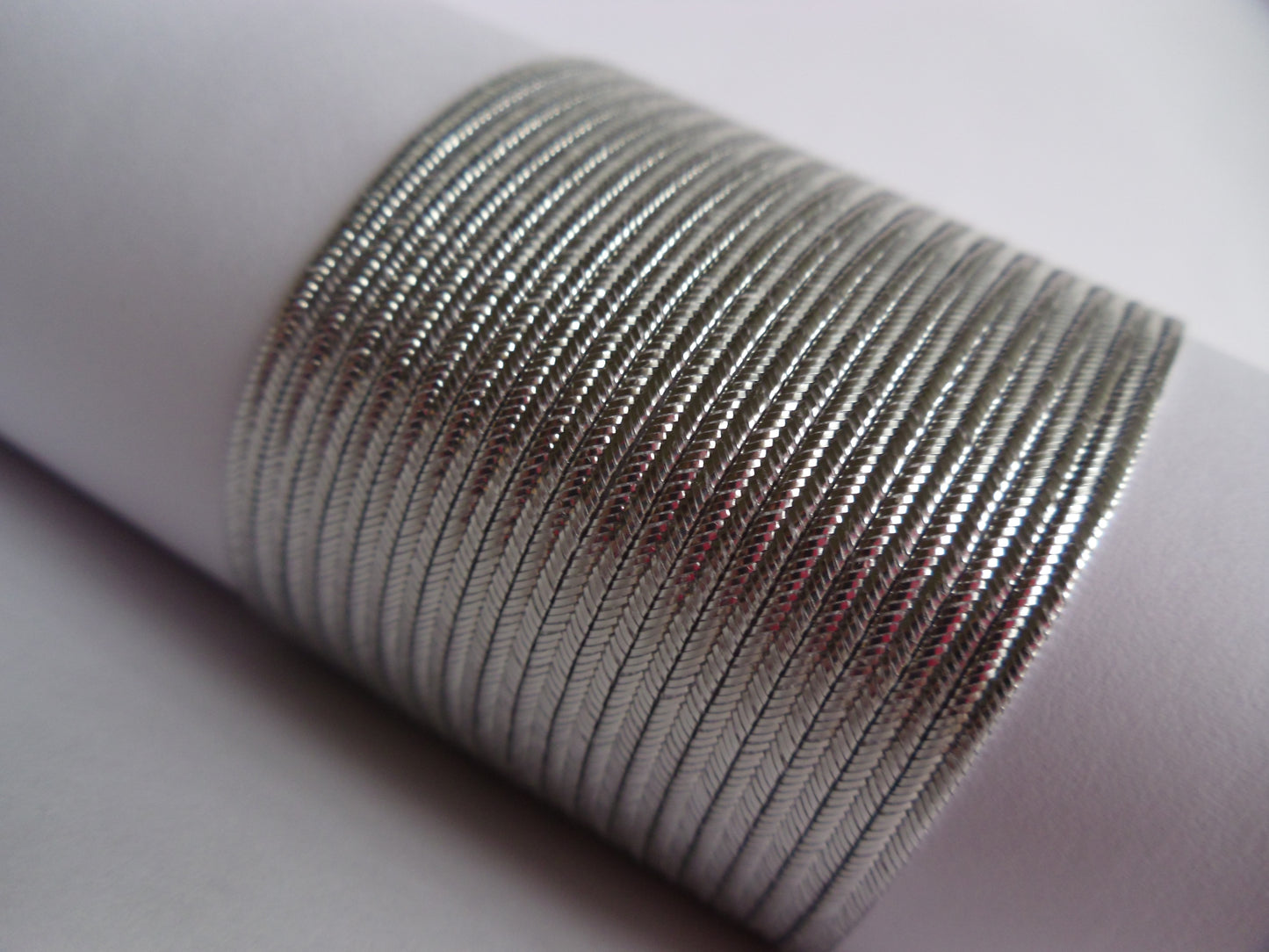 2mm metallic silver soutache braid trim; glossy silver flat cord for military regalia, bridal embroidery, and high-end jewellery making; professional-grade Czech cord with a bright, reflective metallic finish.