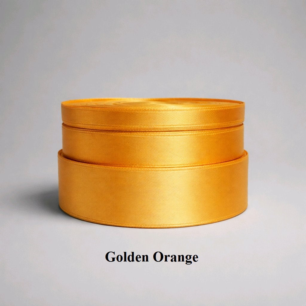 A rich dark yellow/amber shade of 25mm satin silky ribbon perfect for harvest-themed decor and autumn weddings.