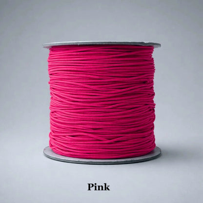 1mm pink nylon-covered elastic thread with a smooth fabric finish, a popular choice for children’s jewelry, "friendship" bracelets, and feminine beaded designs