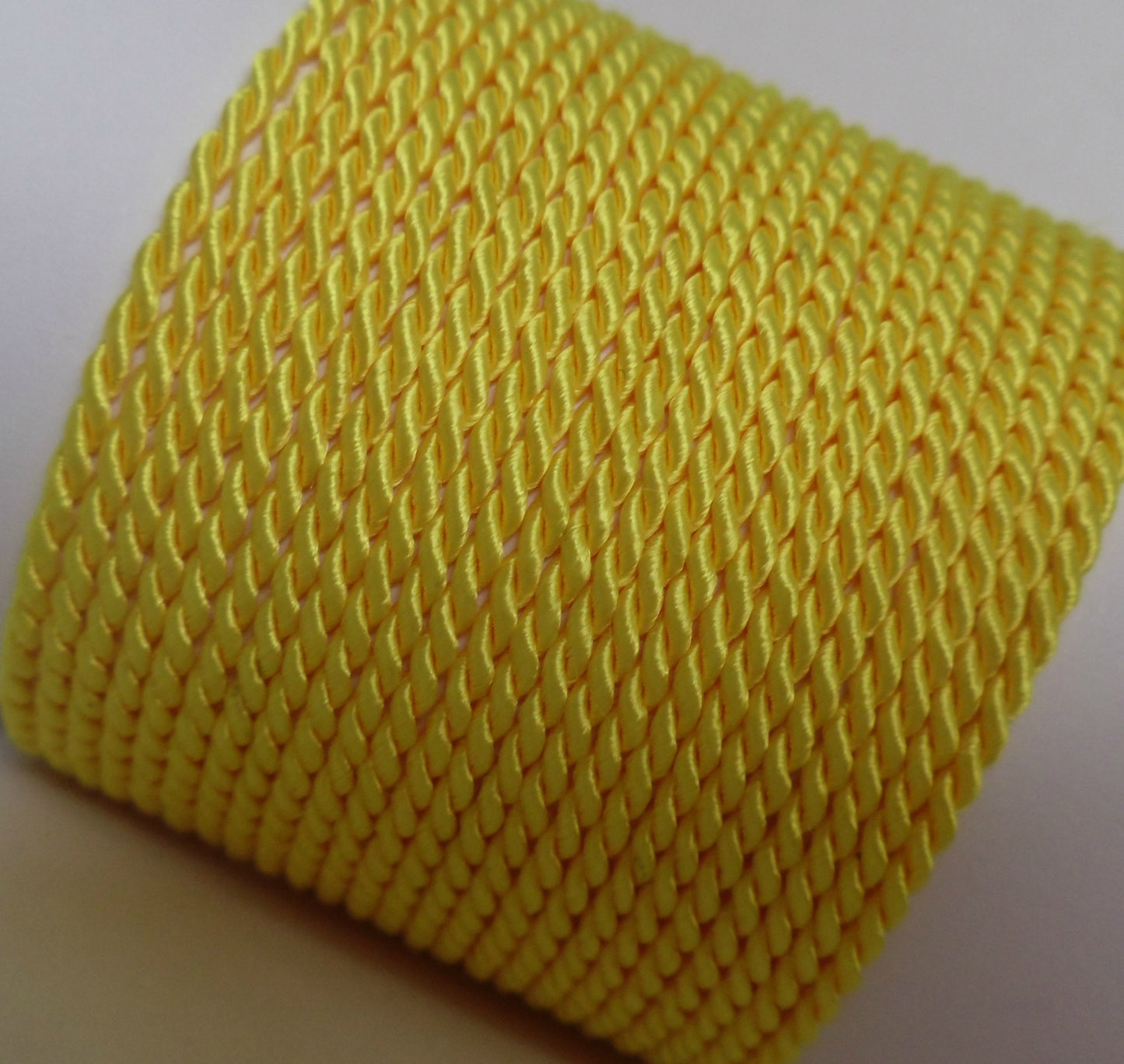 2mm lemon yellow twisted cord; bright citrus-toned rope for cheerful craft projects and summer-themed gift wraps.