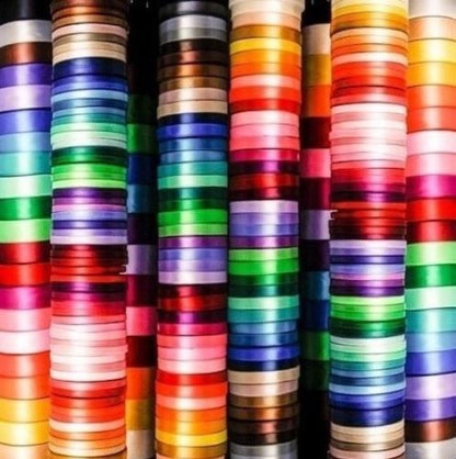 Stacks of colorful ribbons in various hues.