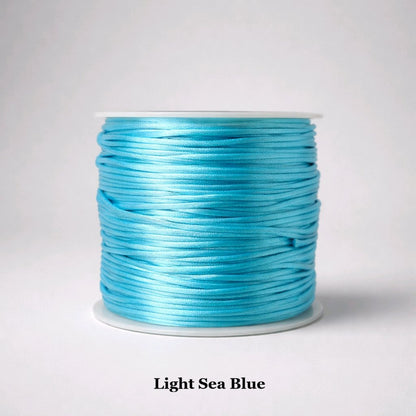 1mm light sea blue rattail satin cord; soft aqua-toned silky nylon string for coastal-themed jewellery, ocean-inspired micro-macramé, and delicate tropical friendship bracelets.