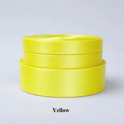 6mm bright yellow single-sided satin ribbon; vibrant 32m reel for cheerful gift wrapping and children's crafts. 